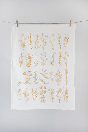 White tea towel with yellow wild flowers.