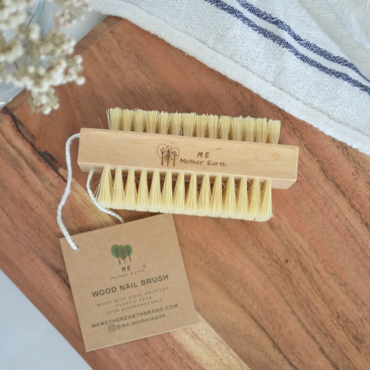 Wooden nail brush on a cutting board.