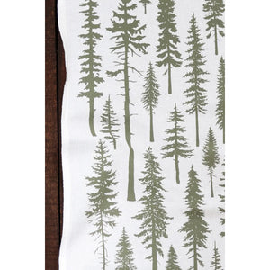 Close up of a white tea towel with green redwood pine trees