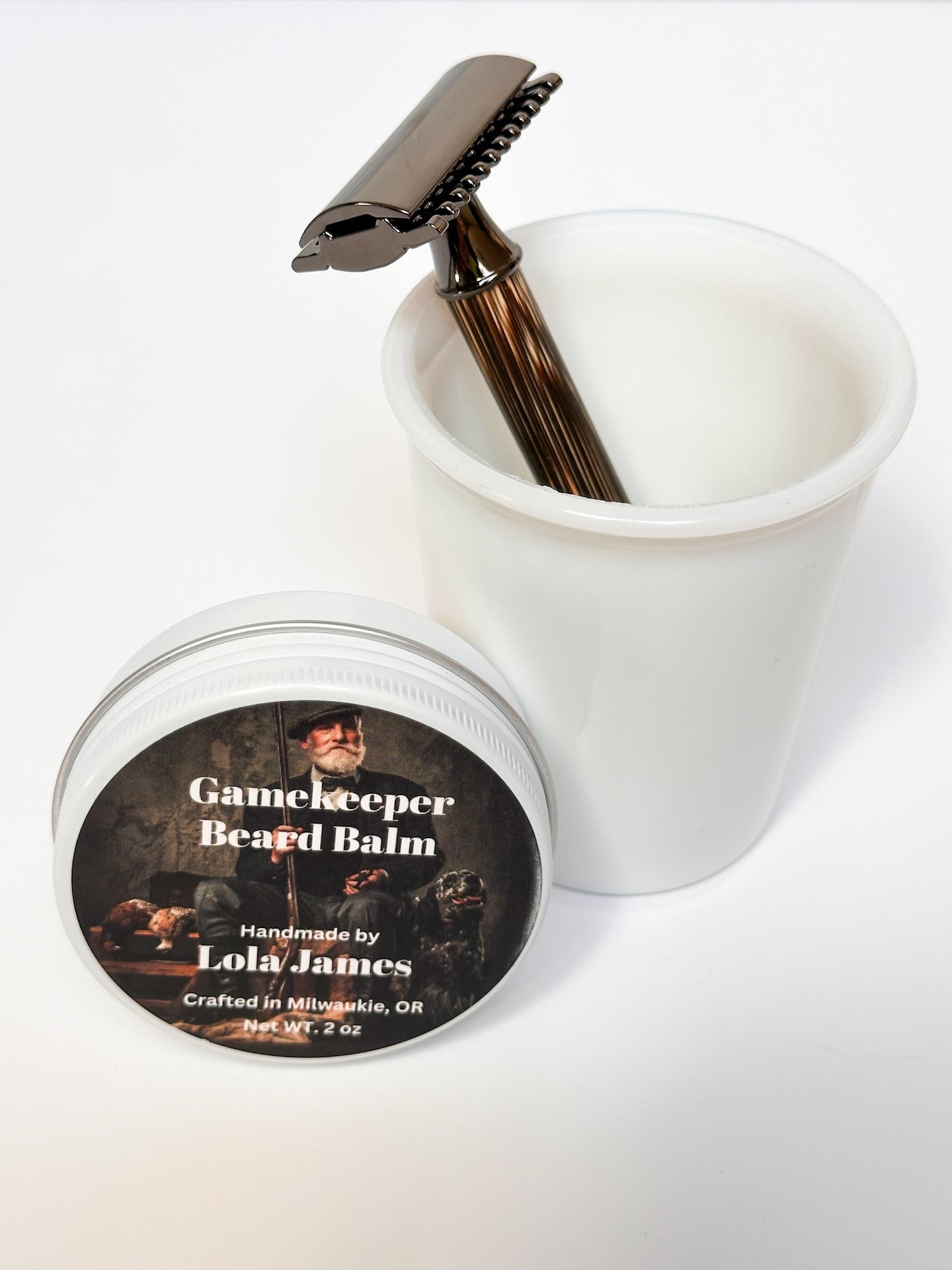 Bamboo and stainless steel razor in milk glass cup with Gamekeeper Beard Balm 