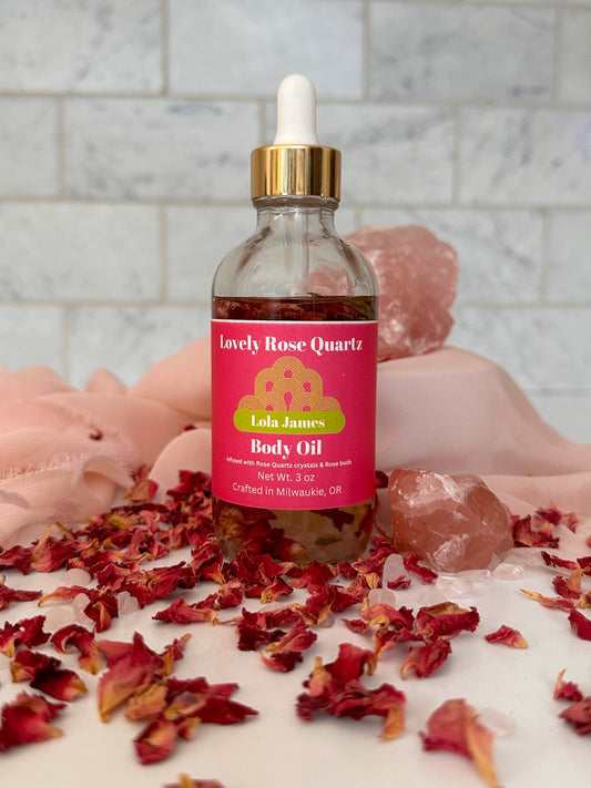 Lola James body oil with rose petals and Rose Quartz crystals.