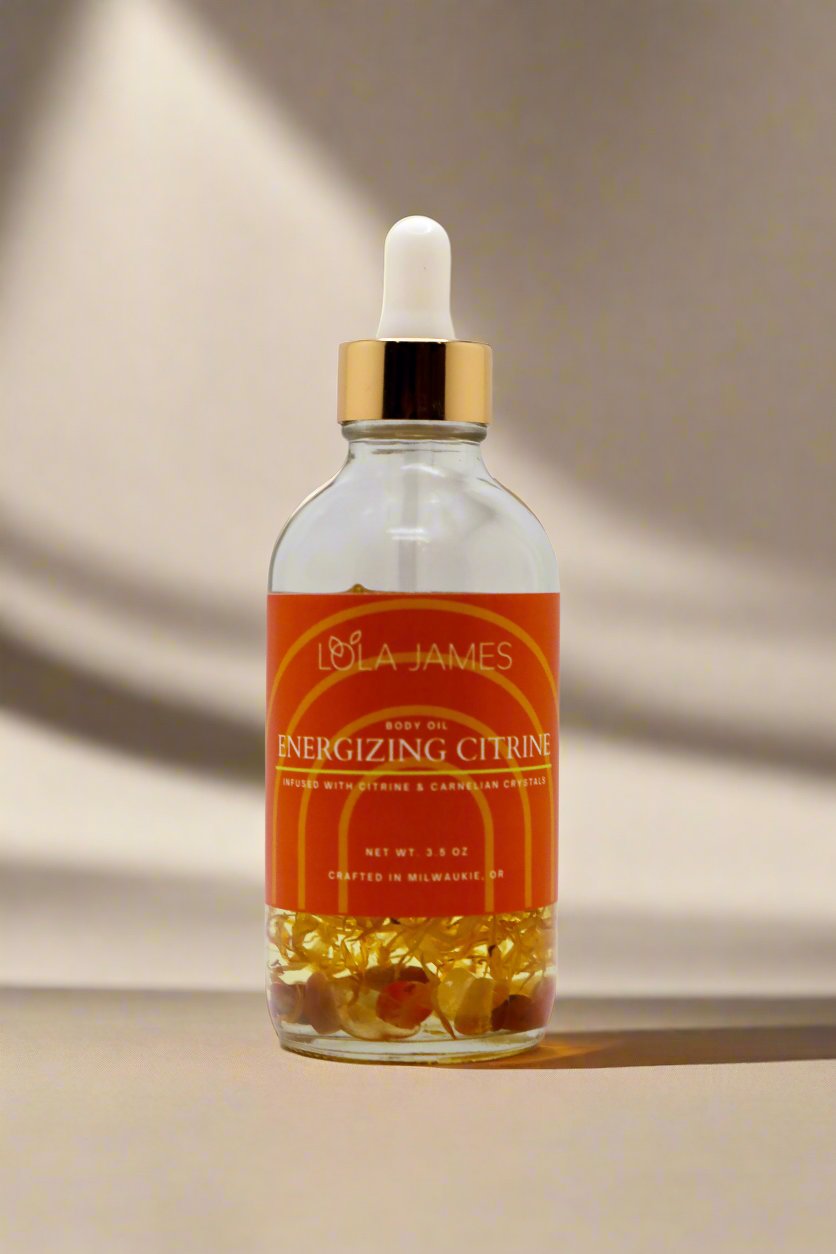 Body oil with orange botanicals and citrine crystals.