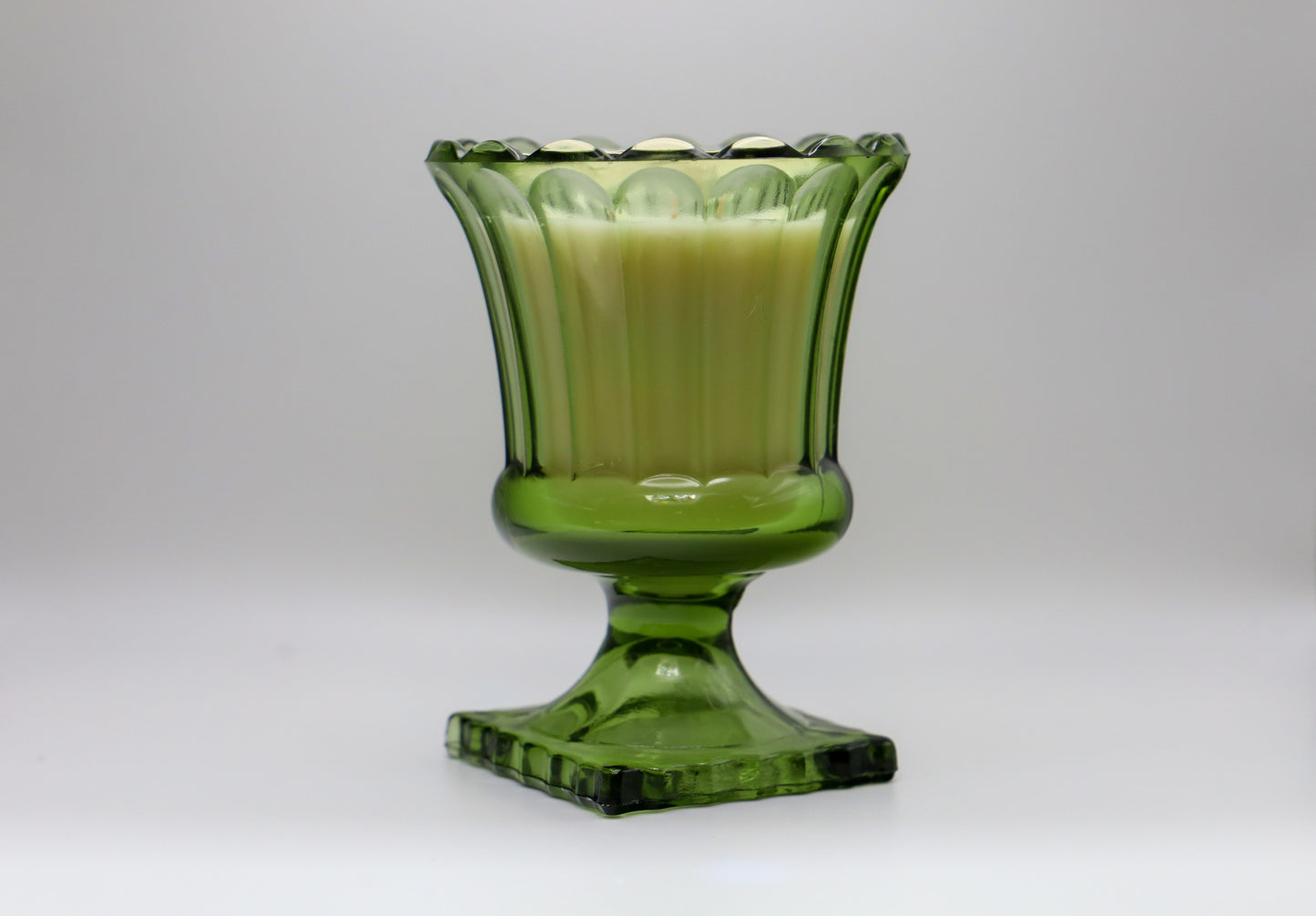 Fluted green glass footed vase by Hazel Atlas with large soy candle in Cactus Flower and Jade scent