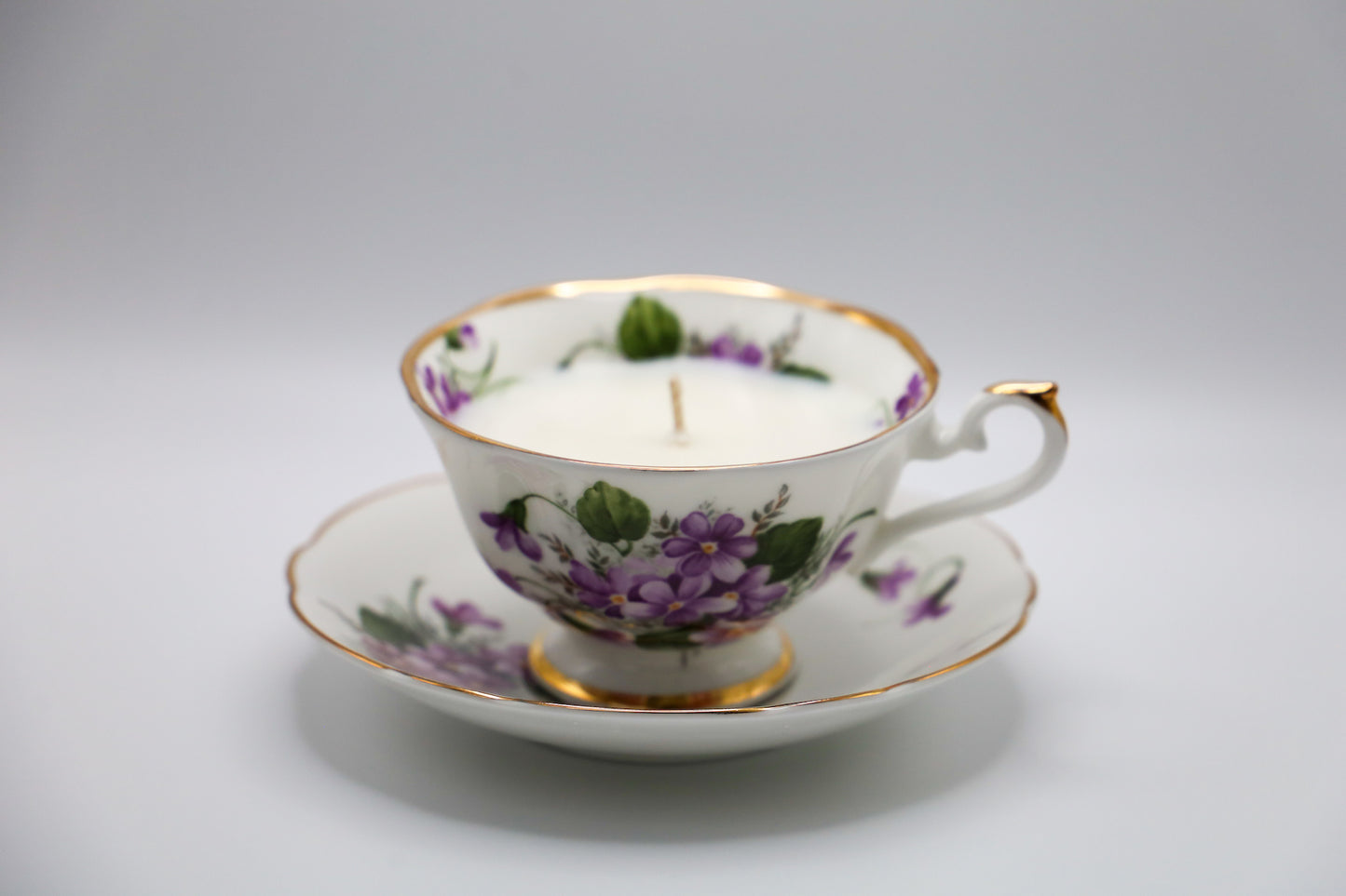 Vivid Violet pattern tea cup and saucer with Lush Succulent scented soy candle.
