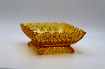 Amber pedestal glass dish with daisy and button pattern