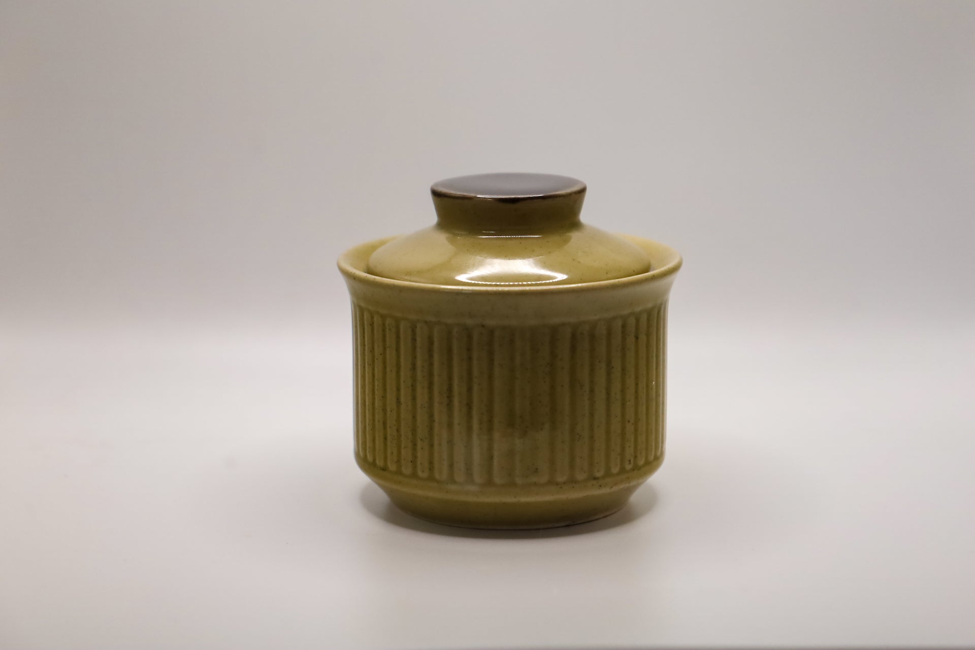 Imperial Stoneware ceramic sugar bowl with lid containing Tonka and Oud scented soy candle