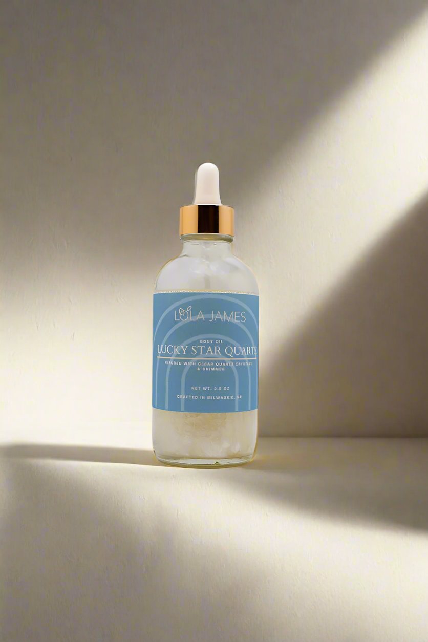 Body oil with blue label and quartz crystals