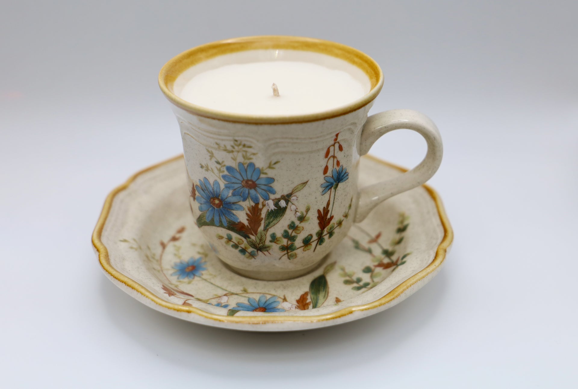 Mikasa Cup and Saucer in Blue Daisies pattern with Apricot Grove scented soy candle
