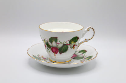 English Bone China Tea cup and saucer with fuchsia motif, filled with lush succulent scented soy candle.