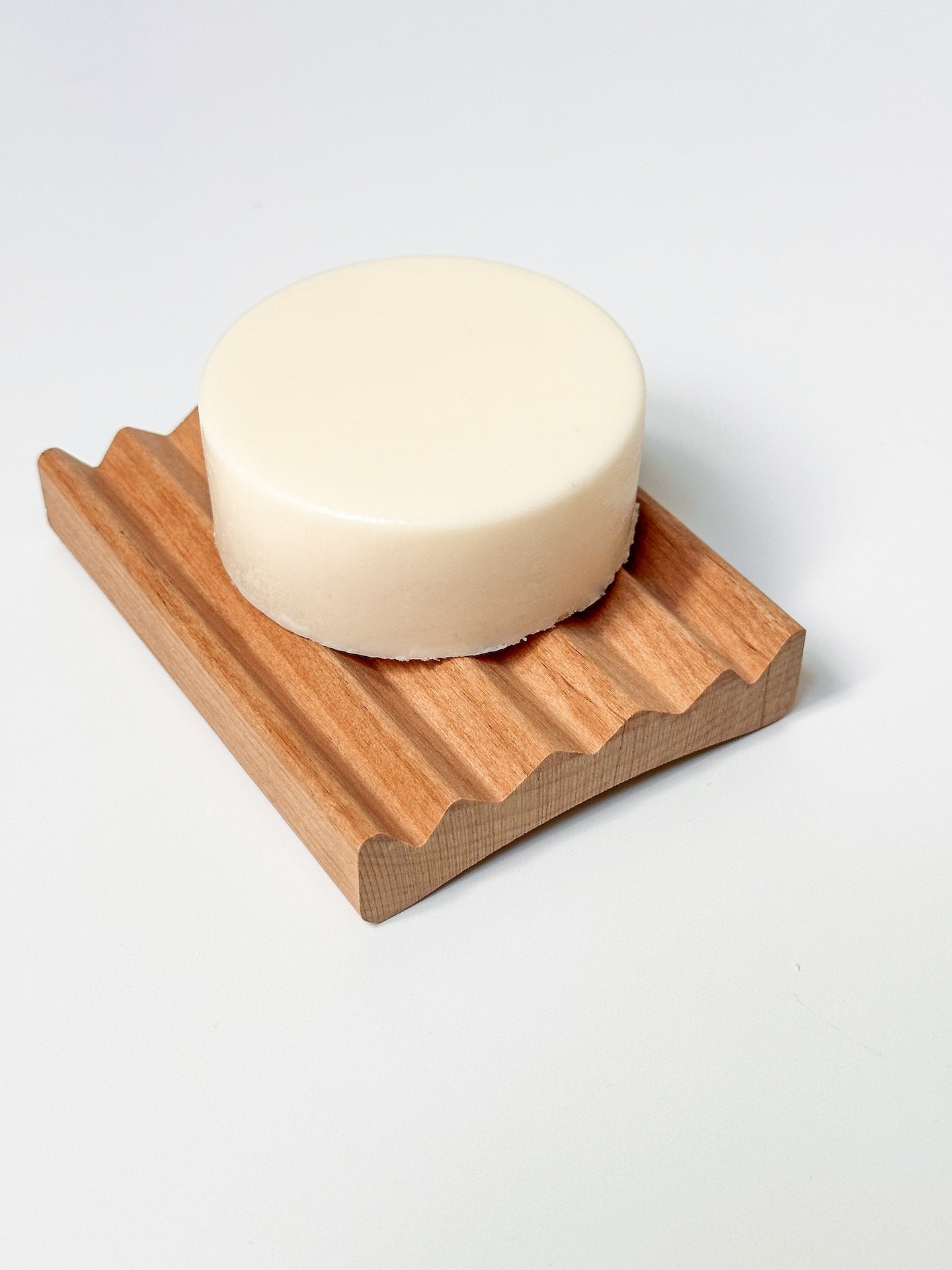 White body butter bar on a wooden tray.