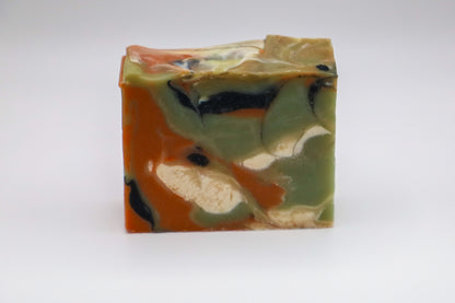 Handmade soap with green, orange, black and white swirls resembling onyx, scented with matcha and apricot