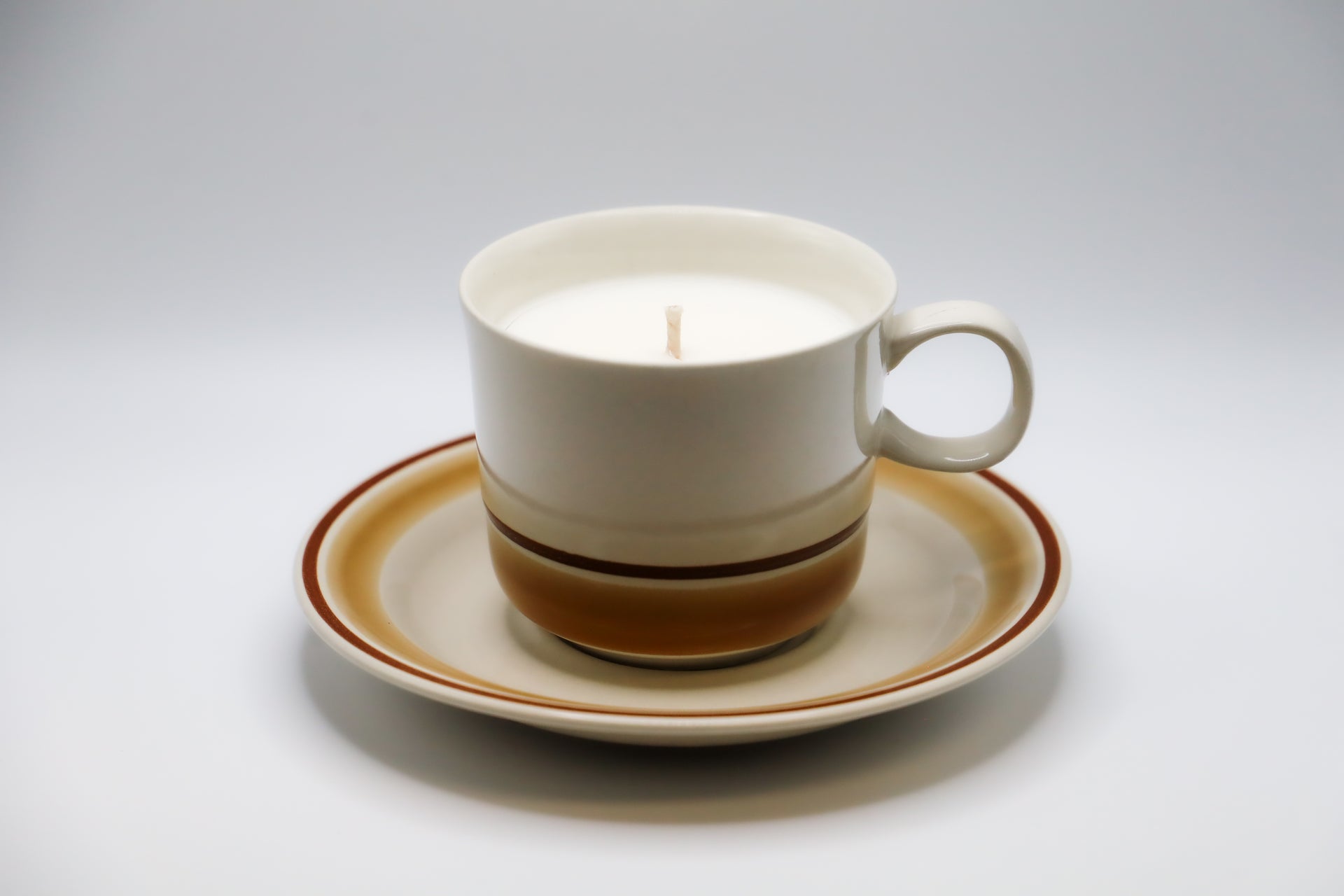 Water Colors Horizon Stoneware Cup and Saucer with hand poured soy candle.
