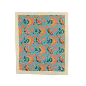 A Swedish dish cloth with a blue background and a watermelon, floral, and rainbow pattern.