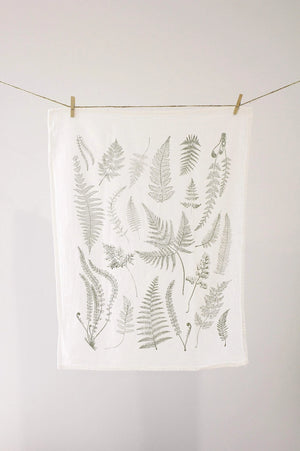 White tea towel with fern fronds.